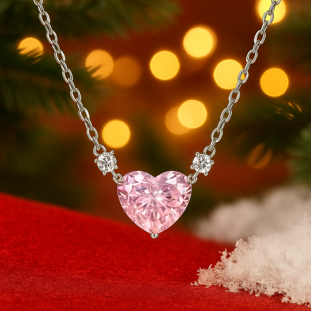 Pink Zirconia Heart Necklace on a red surface with blurred lights in the background