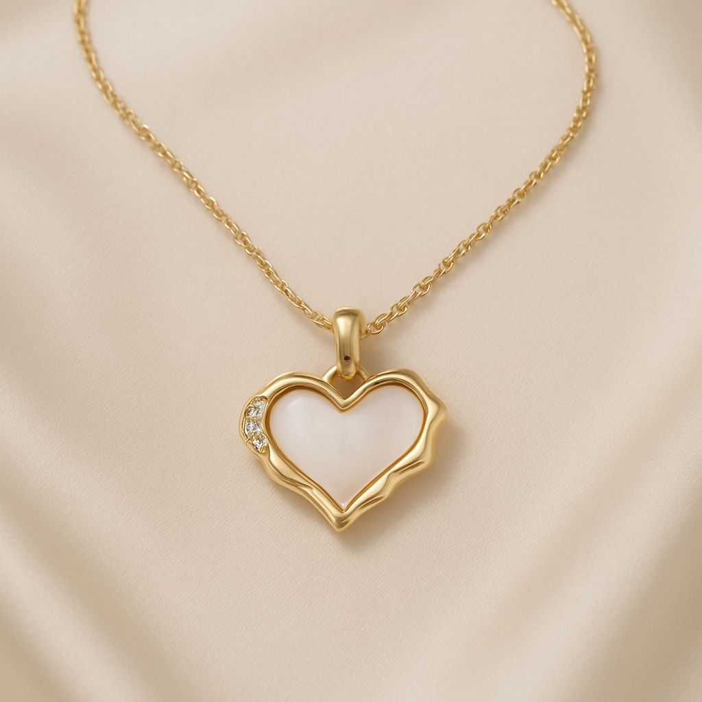 Gold Heart Mother of Pearl Necklace with small diamonds on a white and beige fabric background