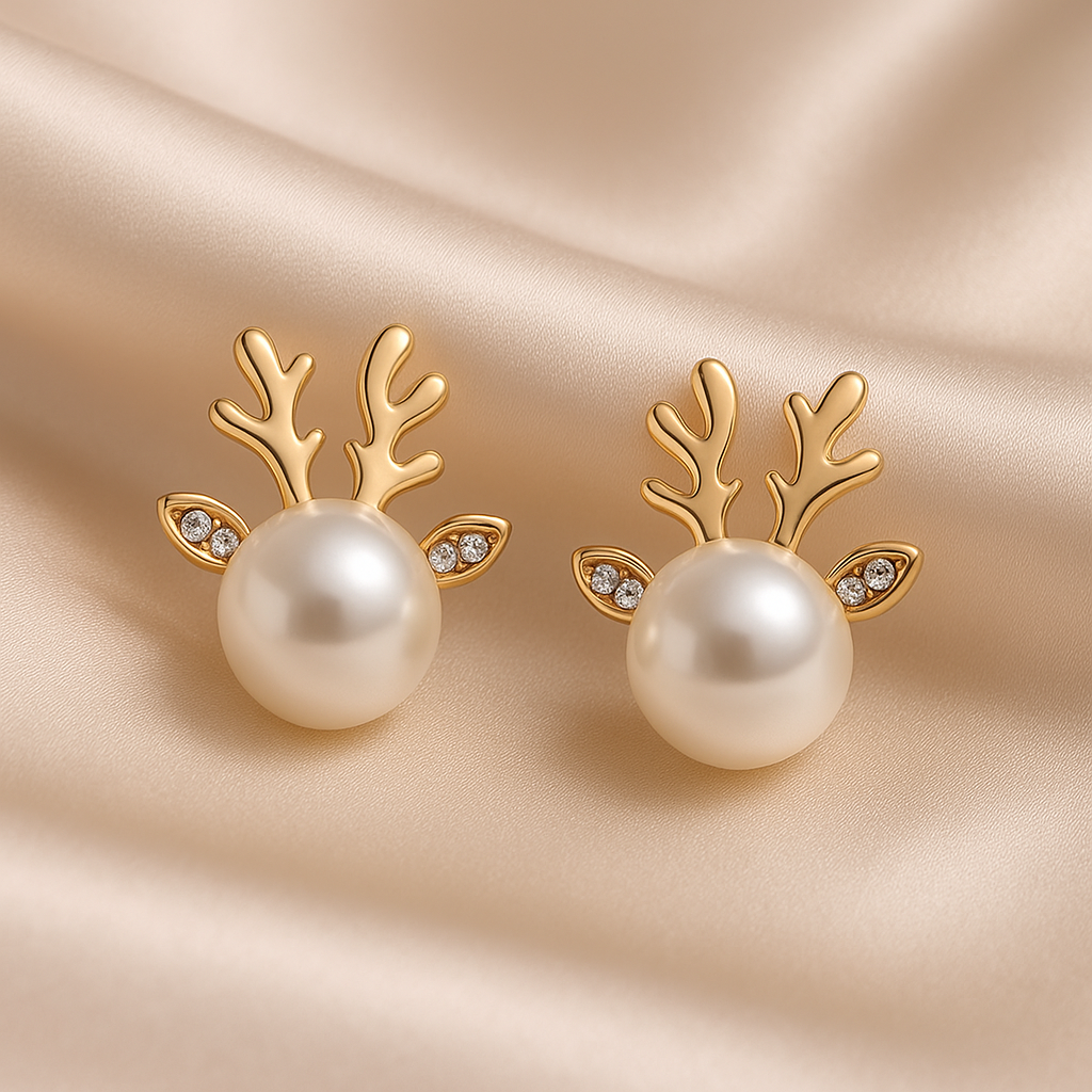 Snow Pearl Reindeer Earrings with pearl centers on a beige satin background