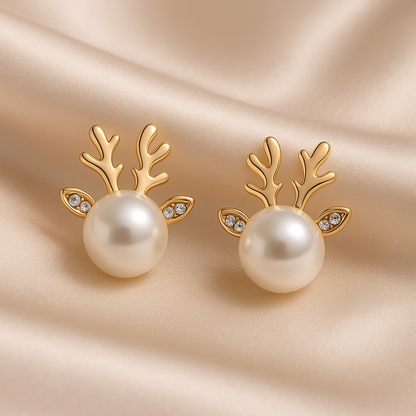Snow Pearl Reindeer Earrings with pearl centers on a beige satin background