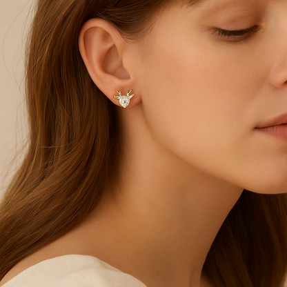 Close-up of a woman wearing Gold Reindeer Zircon Heart Earrings with a neutral background