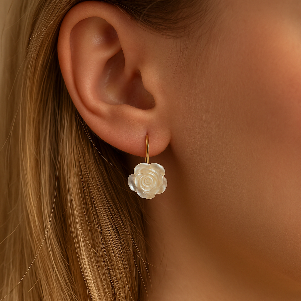 Close-up of an ear wearing a White Rose Earring with a soft focus on the hair and skin.