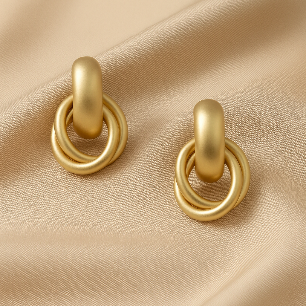 Satin Gold Hoop Earrings on a beige fabric background