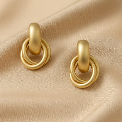 Satin Gold Hoop Earrings on a beige fabric background