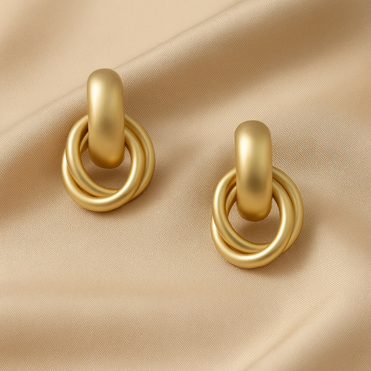 Satin Gold Hoop Earrings on a beige fabric background