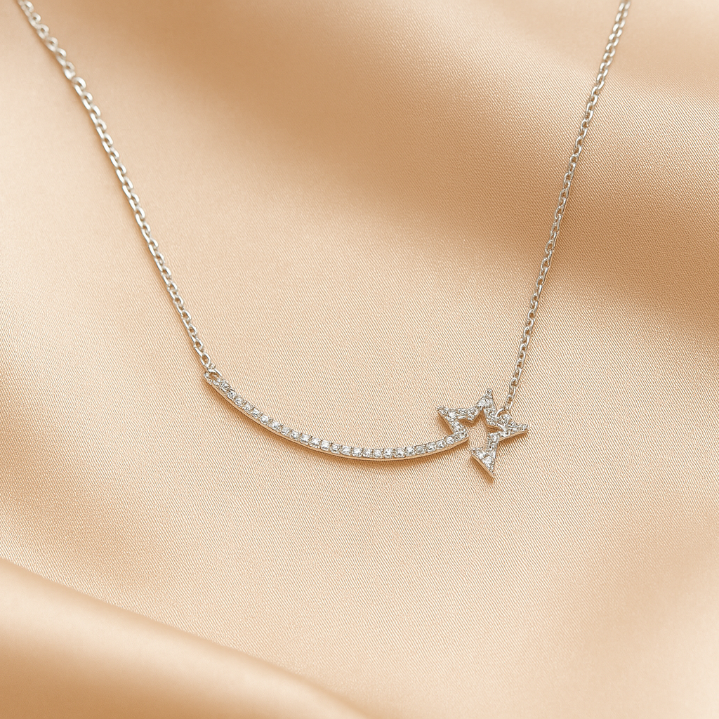 Delicate silver shooting star necklace with a star pendant on a soft beige fabric background
