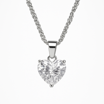 Heart-shaped diamond pendant on a silver chain against a white background