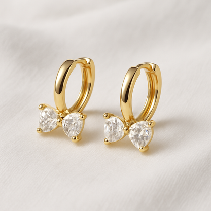Gold Zircon Bow Hoop Earrings on a light background