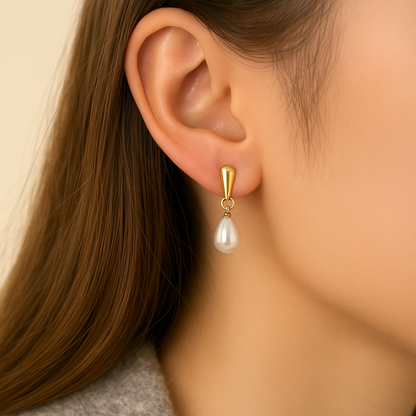 Gold Pearl Teardrop Earrings worn by a person