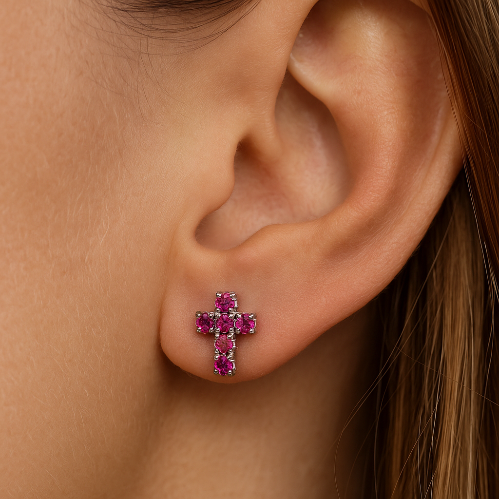 Close-up of a woman wearing a Pink Rhinestone Cross Earring