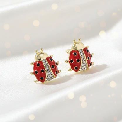 Crystal Accent Ladybug Earrings with gold accents on a white background