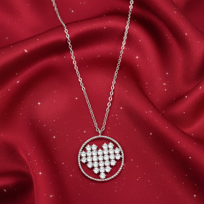 Rhinestone Circle Heart Necklace with a heart-shaped pendant on a red fabric background