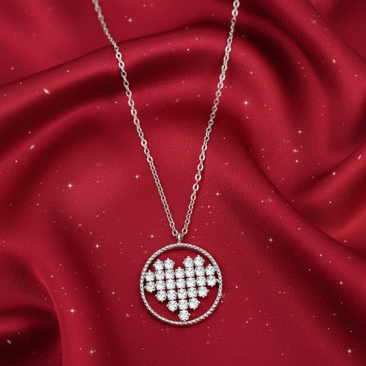 Rhinestone Circle Heart Necklace with a heart-shaped pendant on a red fabric background