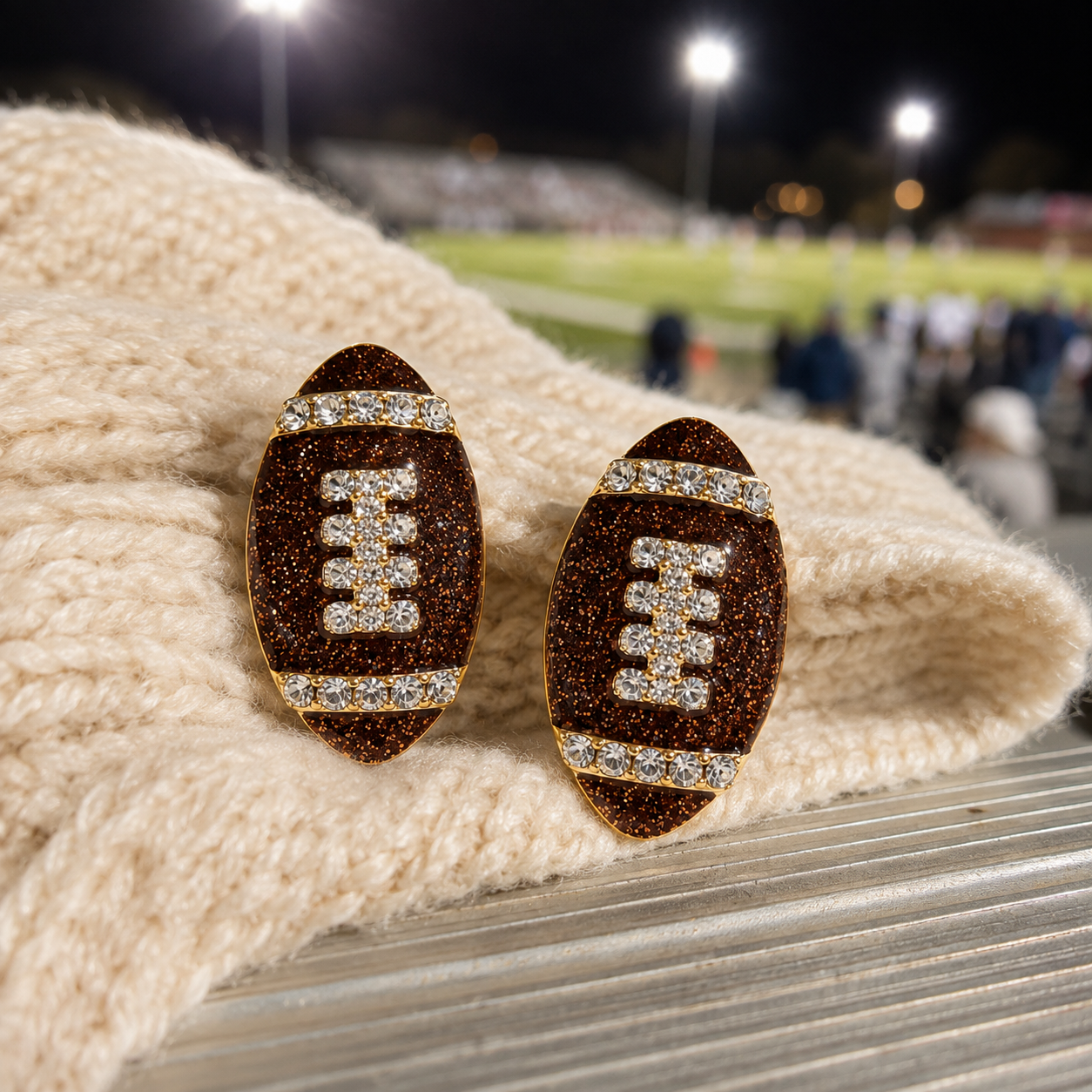 Game Day Sparkle Football Earrings on sweater on bleachers