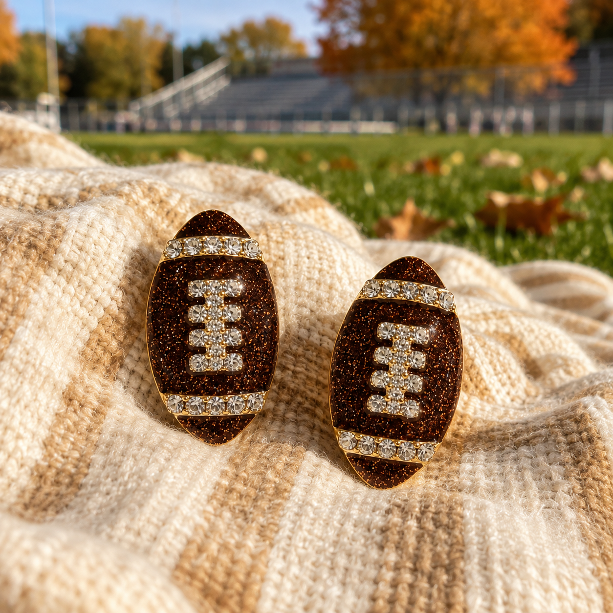 Game Day Sparkle Football Earrings on blanket on field