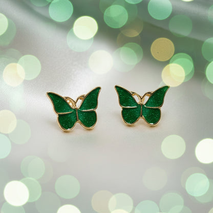 Garden Green Butterfly Earrings on a blurred green and white background
