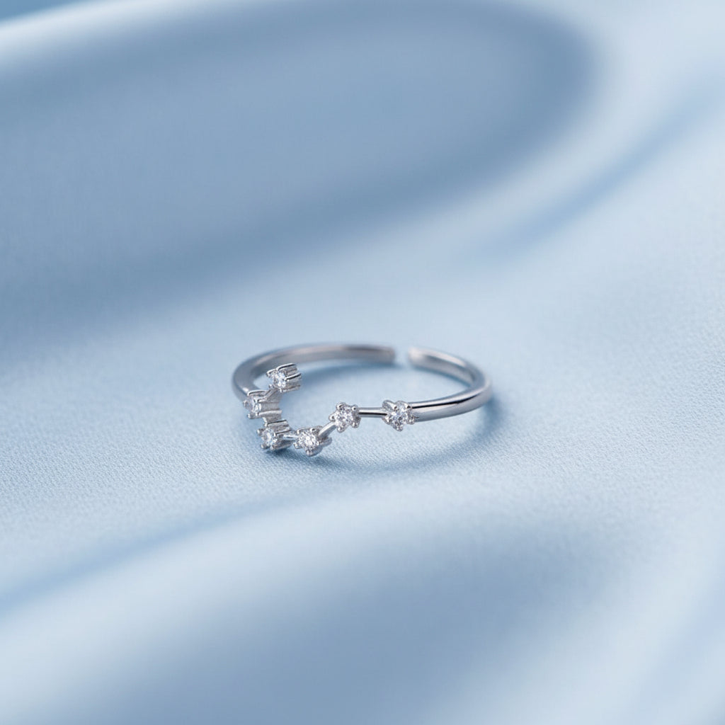 Gemini Ring on a light blue fabric background