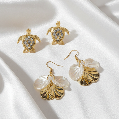 Gold Pavé Sea Turtle & White Gold Seashell Earring Set on a white background