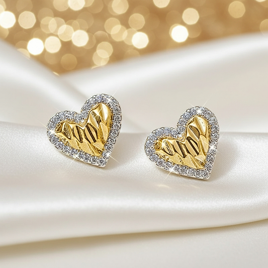 Gold Shimmer Heart Earrings with diamond accents on a white and gold background