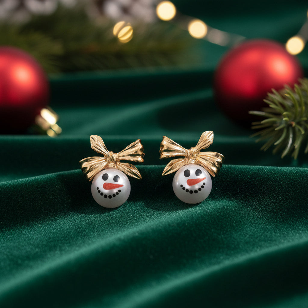 Golden Bow Snowman Earrings on green velvet