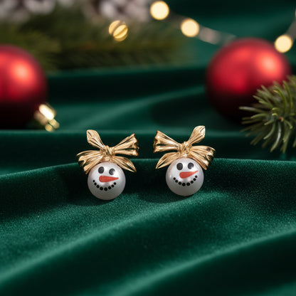 Golden Bow Snowman Earrings on green velvet