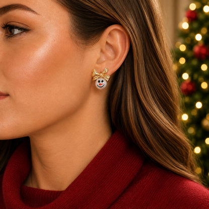 A close-up of a woman wearing a Golden Bow Snowman Earring in red