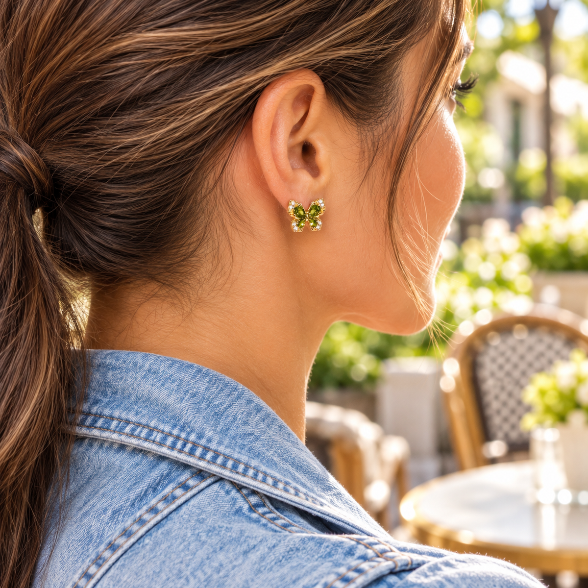 Woman wearing Golden Green Crystal Butterfly Earrings at a cafe