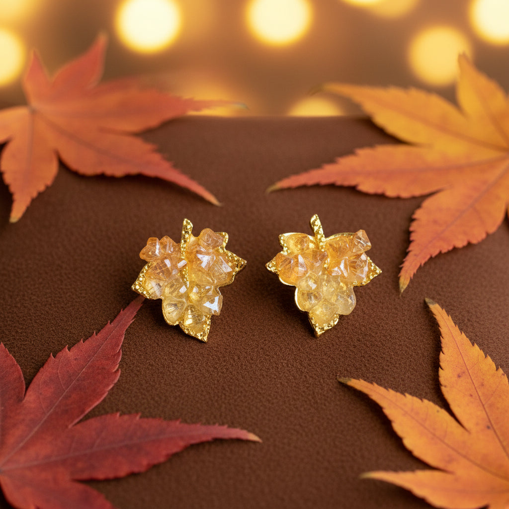 Golden Maple Leaf Earrings on brown suede