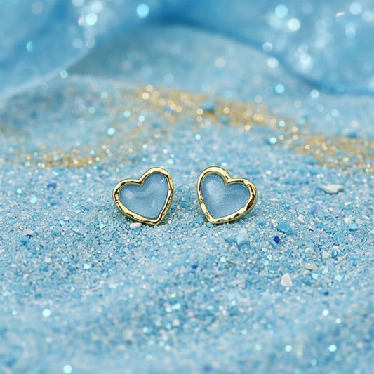 Aqua Blue Opalescent & Gold Heart Earrings on a white dish.
