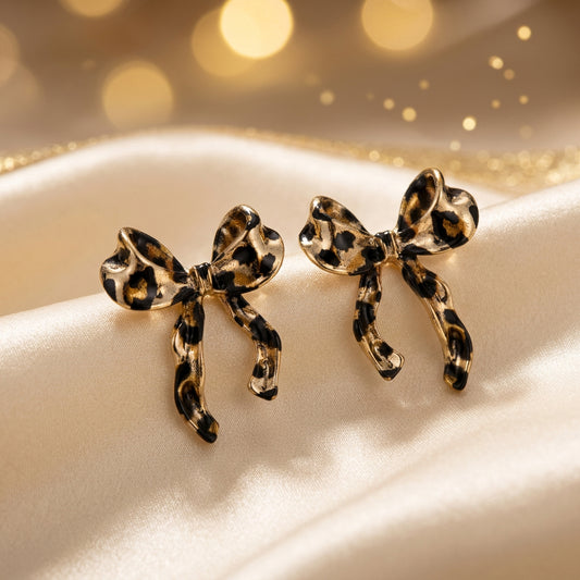 Leopard print bow-shaped earrings with measurements on a white background