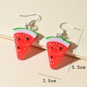 Watermelon slice earrings with measurements on a beige background