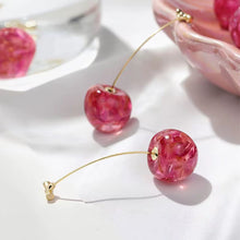 Load image into Gallery viewer, Gold stud earrings shaped like pink cherries with glossy finish