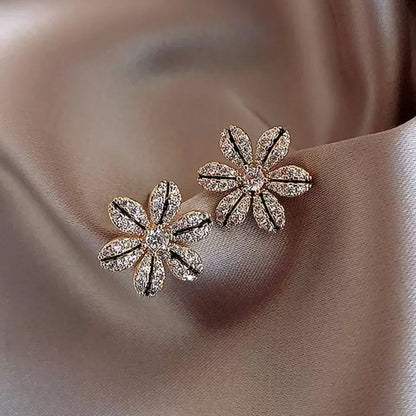 Black & Gold Rhinestone Flower Earrings  with gemstones on a soft fabric background