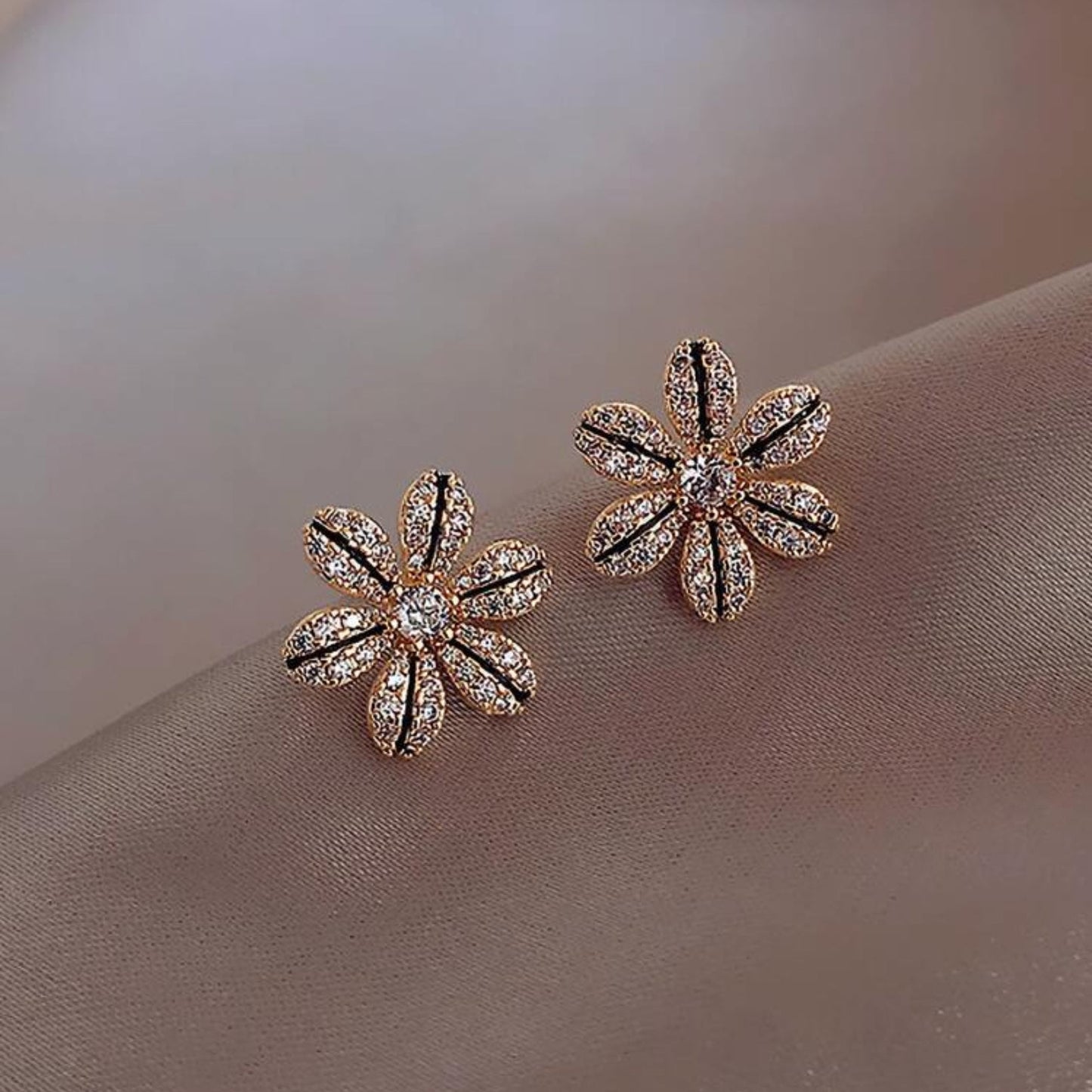 Black & Gold Rhinestone Flower Earrings on a soft beige background