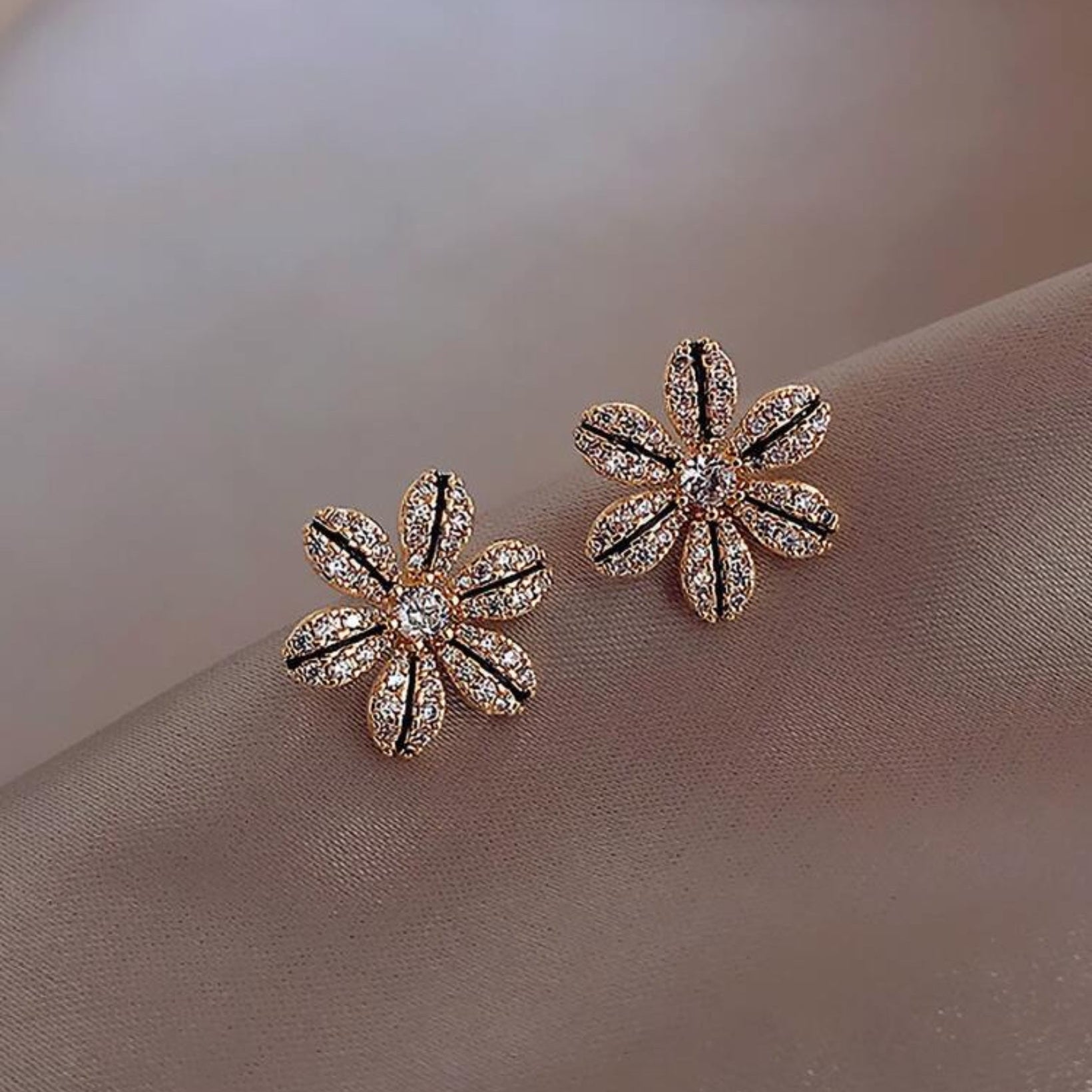 Black & Gold Rhinestone Flower Earrings on a soft beige background