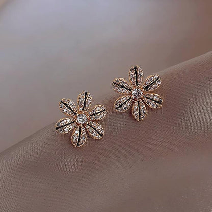 Black & Gold Rhinestone Flower Earrings on a soft beige background