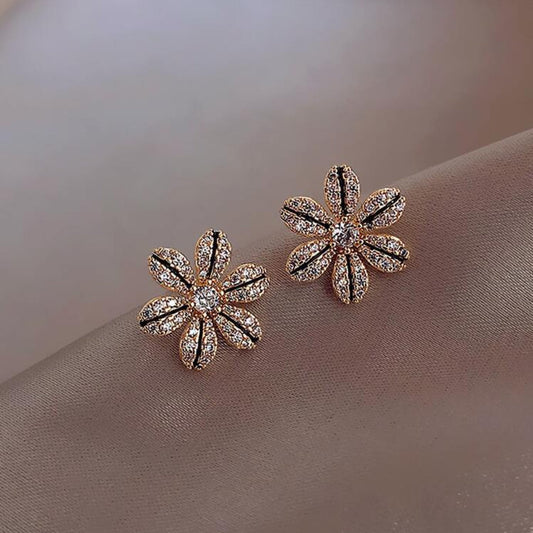 Black & Gold Rhinestone Flower Earrings on a soft beige background