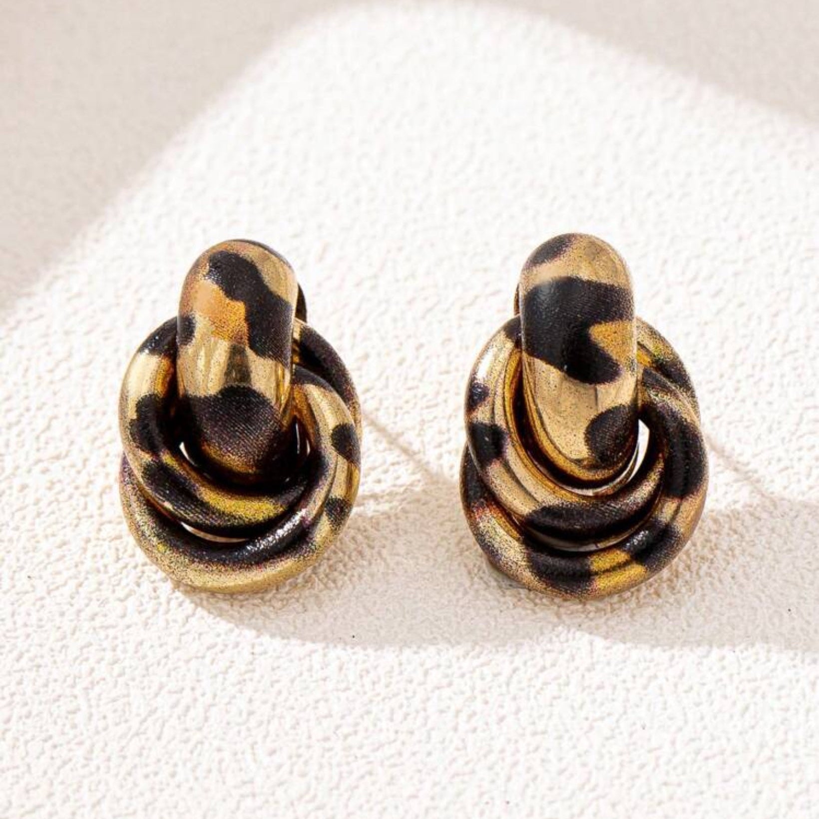 Pair of Leopard Circle Knot Earrings on a white background