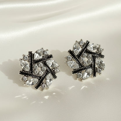 Midnight Silver & Black Crystal Snowburst Earrings with a gray background