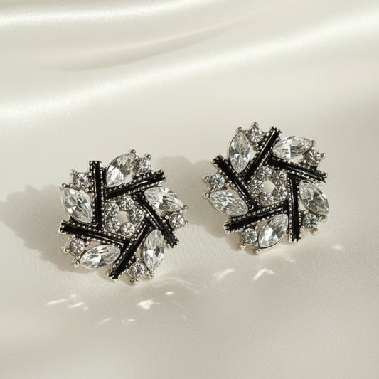 Midnight Silver & Black Crystal Snowburst Earrings with a gray background
