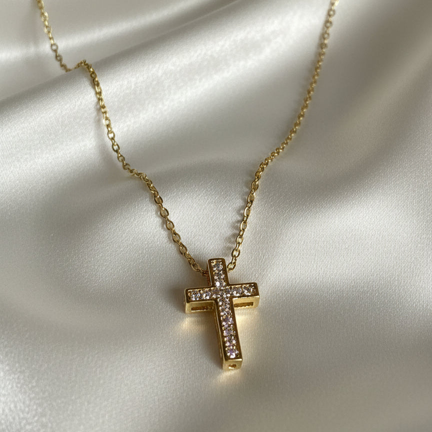 Gold Zirconia Mini Cross Necklace on satin fabric