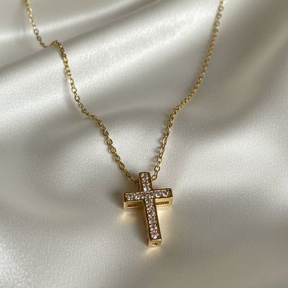Gold Zirconia Mini Cross Necklace on satin fabric