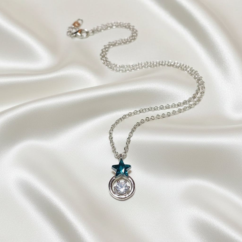 Midnight Star Halo Necklace with a star-shaped pendant on a textured surface