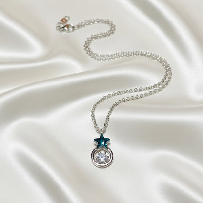 Midnight Star Halo Necklace with a star-shaped pendant on a textured surface