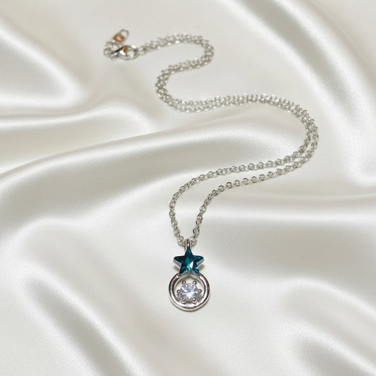 Midnight Star Halo Necklace with a star-shaped pendant on a textured surface