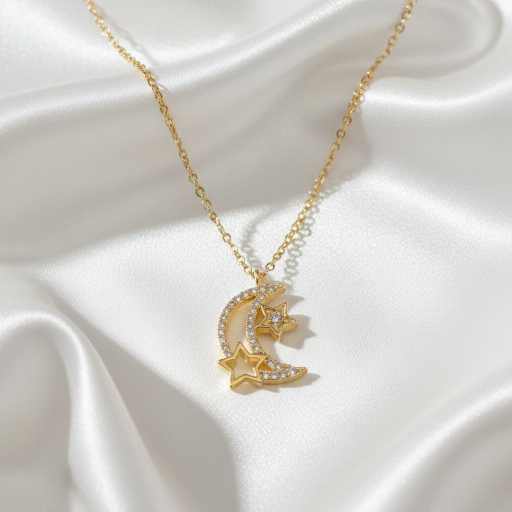 Gold necklace with moon and star pendant on a light blue background