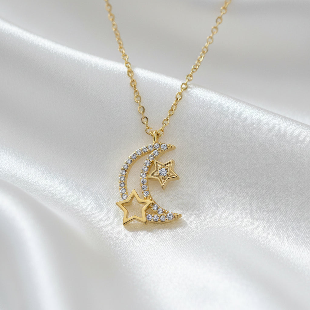 Gold necklace with star and moon pendant on a light blue background