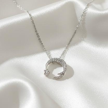 Silver necklace with moon and star pendant on a light blue background with 'Jewelry' text.