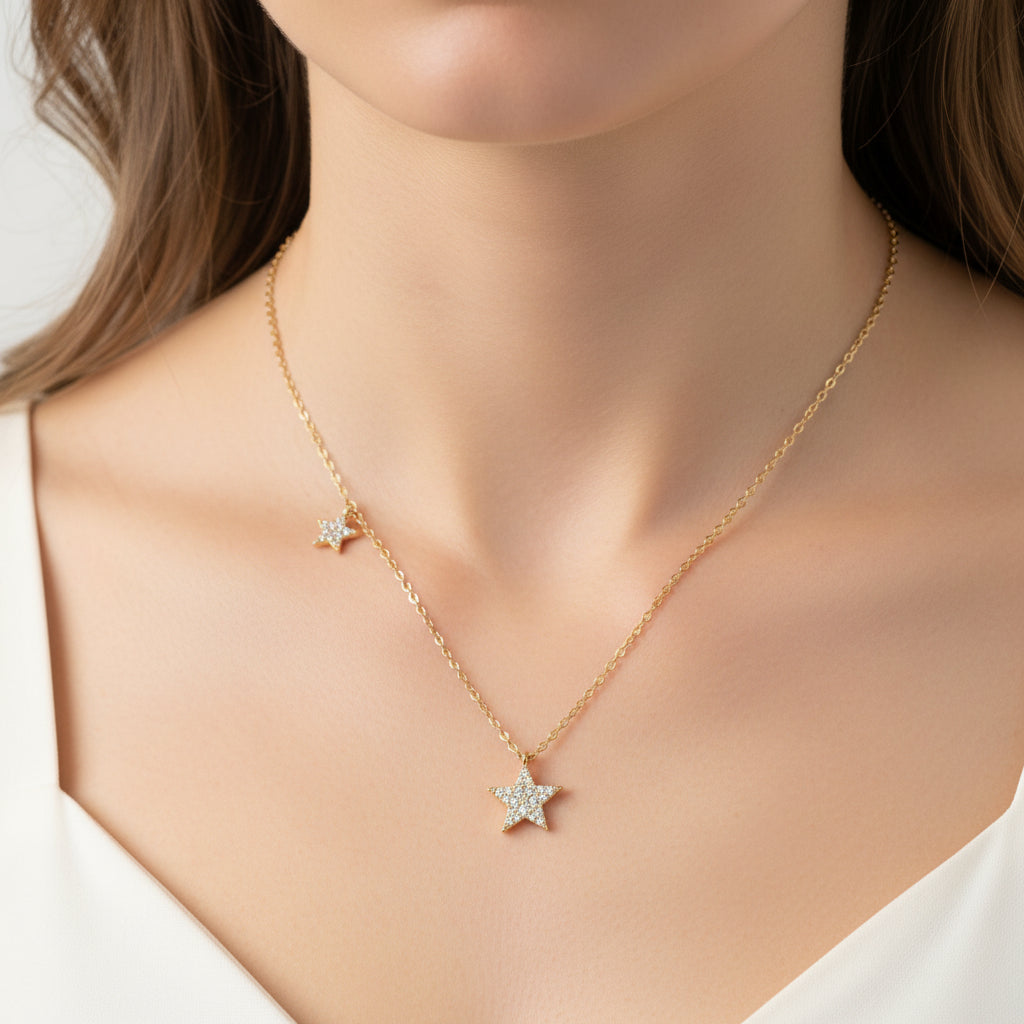 Gold Double Star Necklace with star pendants on a light blue background
