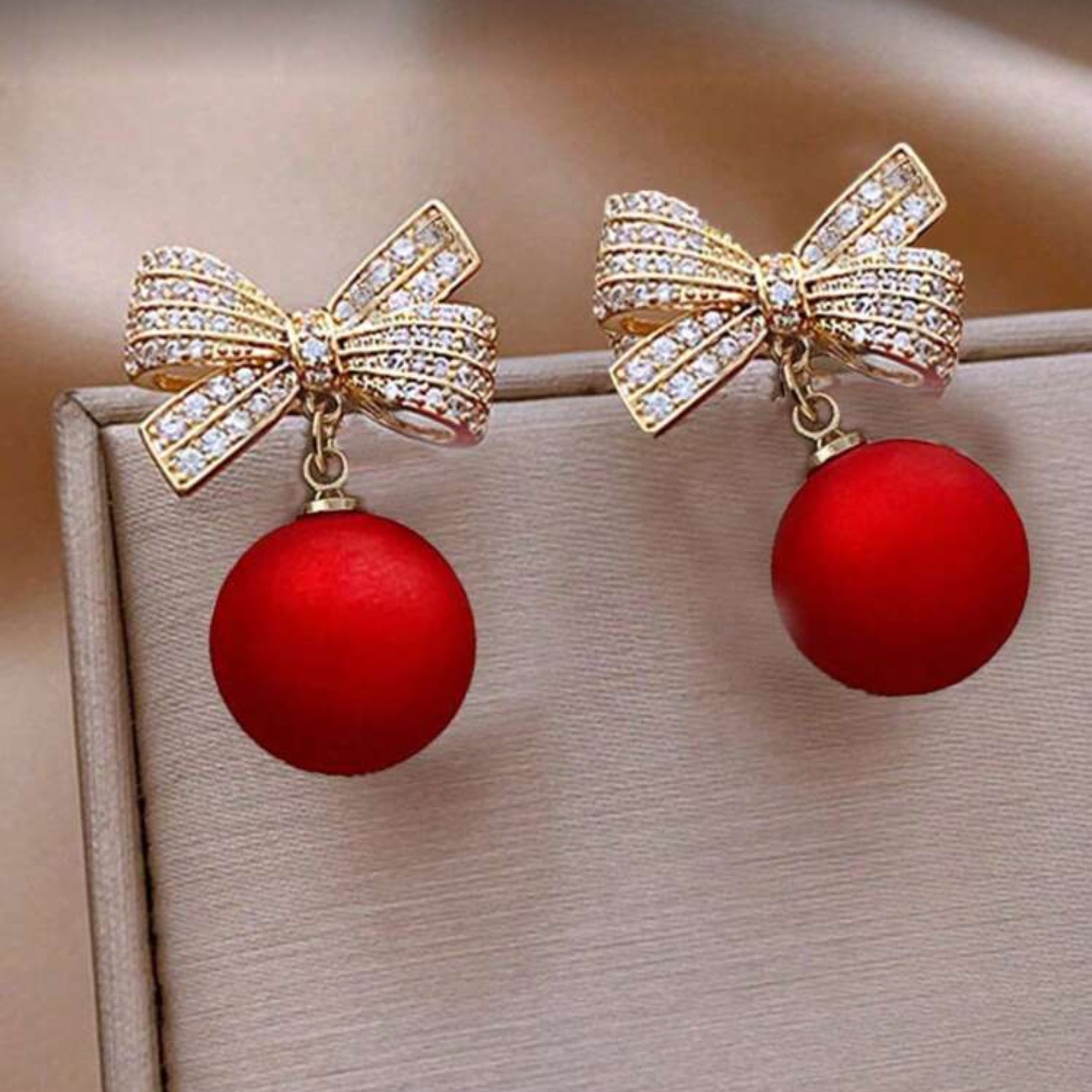 Red Ornament Bow Earrings on display